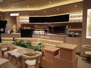 Modern CHAGEE tea bar interior with seating and pickup counter